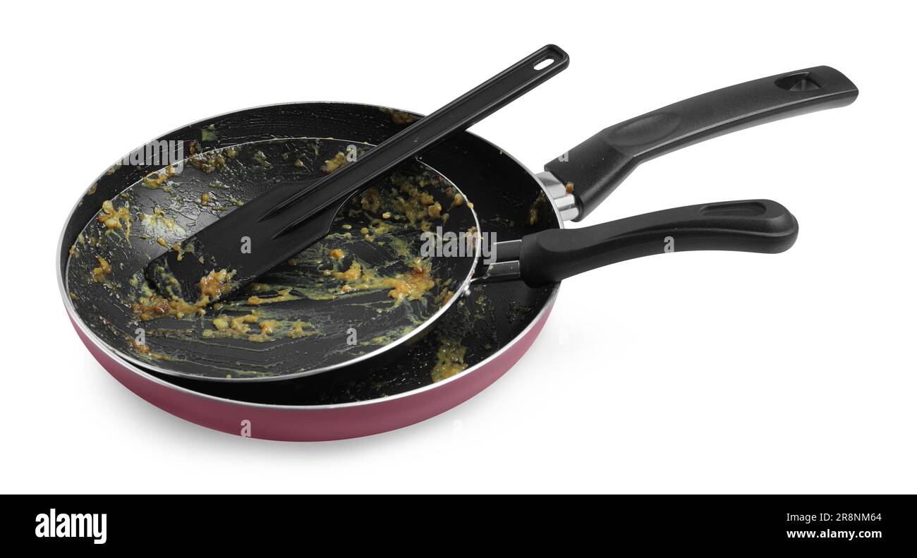Dirty frying pans and spatula on white background Stock Photo