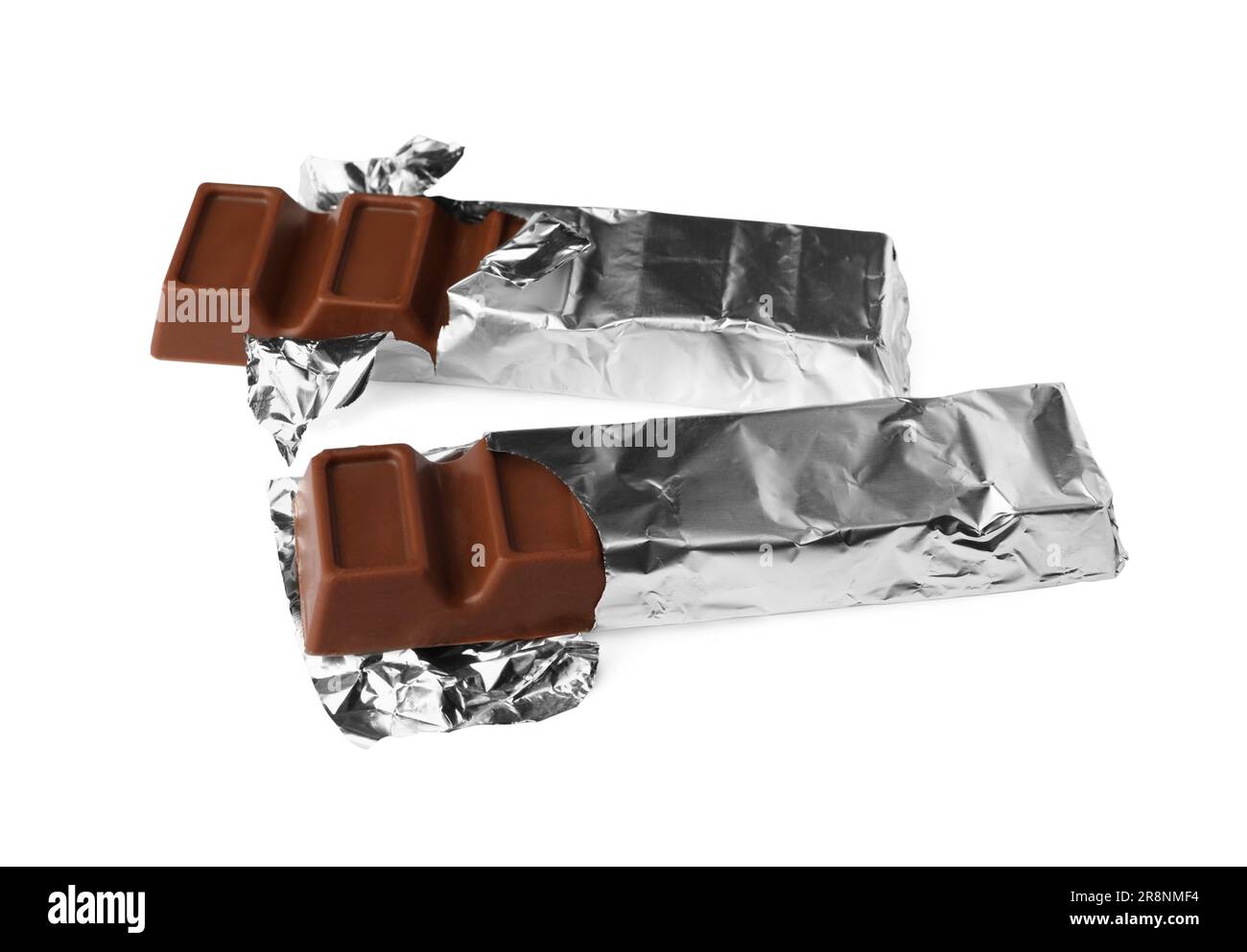 Delicious chocolate bars wrapped in foil on white background Stock ...