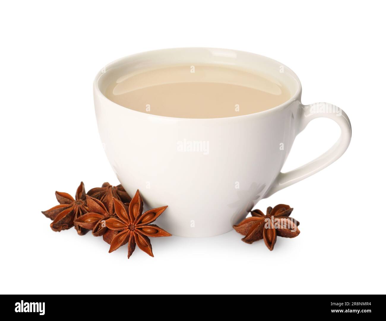 Cup of tea with milk and anise stars on white background Stock Photo