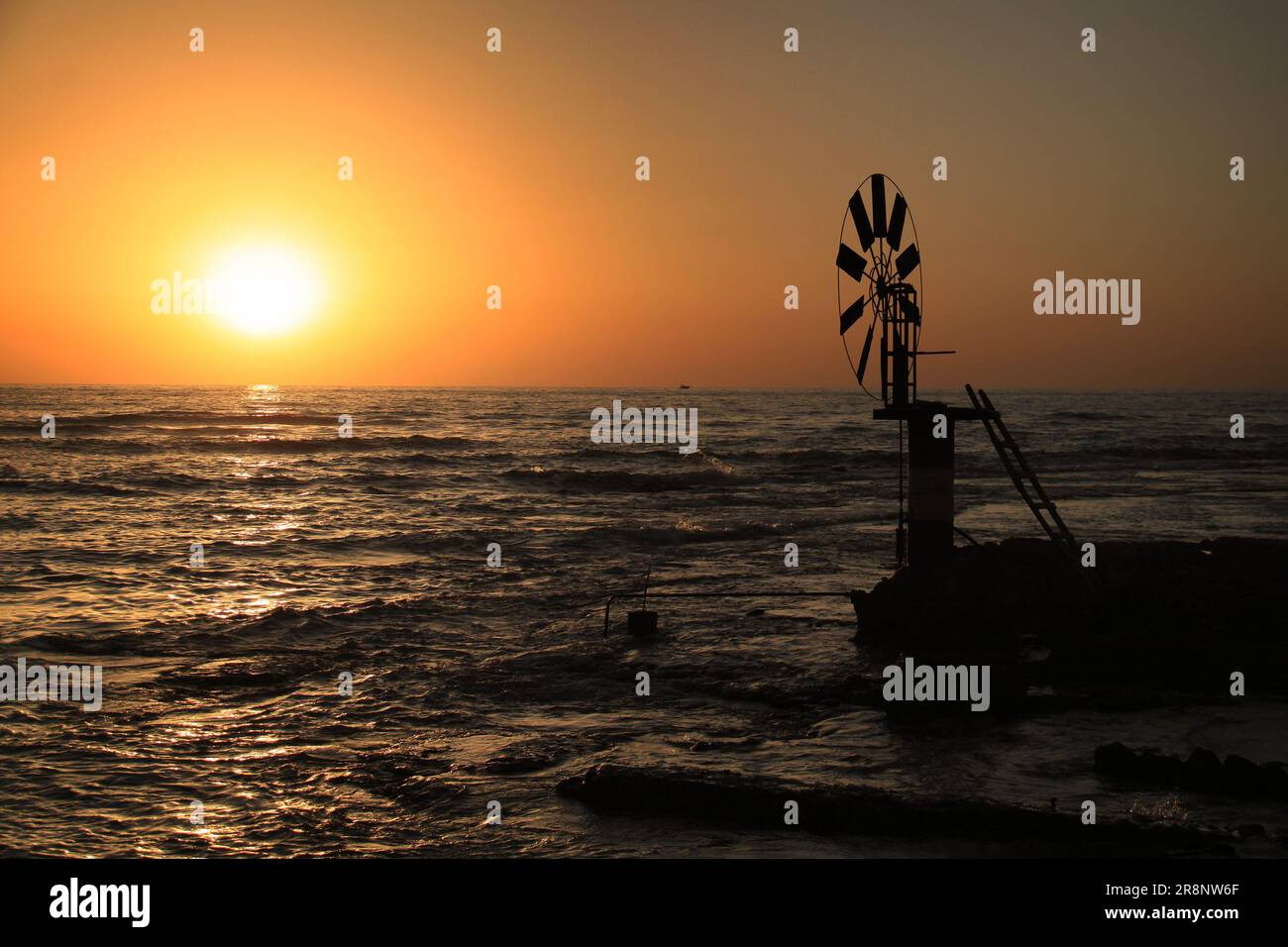 Windmill for extracting sea water for saltmarshes in the coastal city of Anfeh, Lebanon. Stock Photo