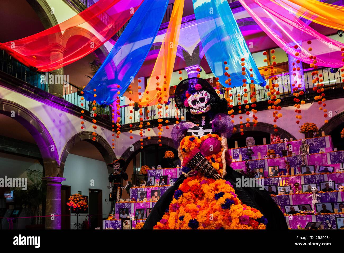 La Catrina figure is placed in front of the altar of the dead (Altar de Muertos) during the Day of the Dead celebrations in Tlaquepaque, Mexico. Stock Photo