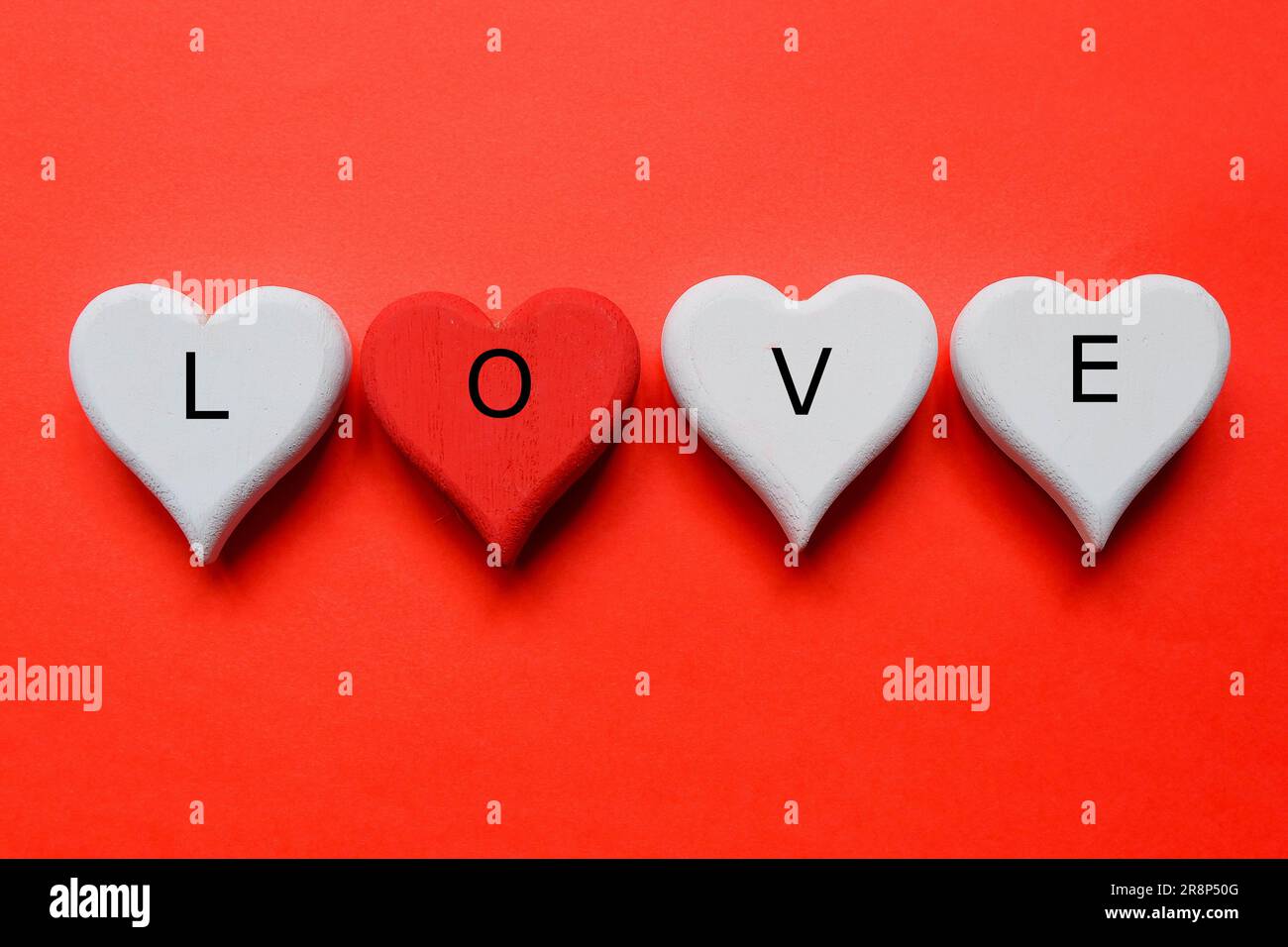 https://c8.alamy.com/comp/2R8P50G/top-view-of-white-and-red-wooden-handcraft-heart-symbol-written-with-love-on-red-background-valentines-day-theme-2R8P50G.jpg