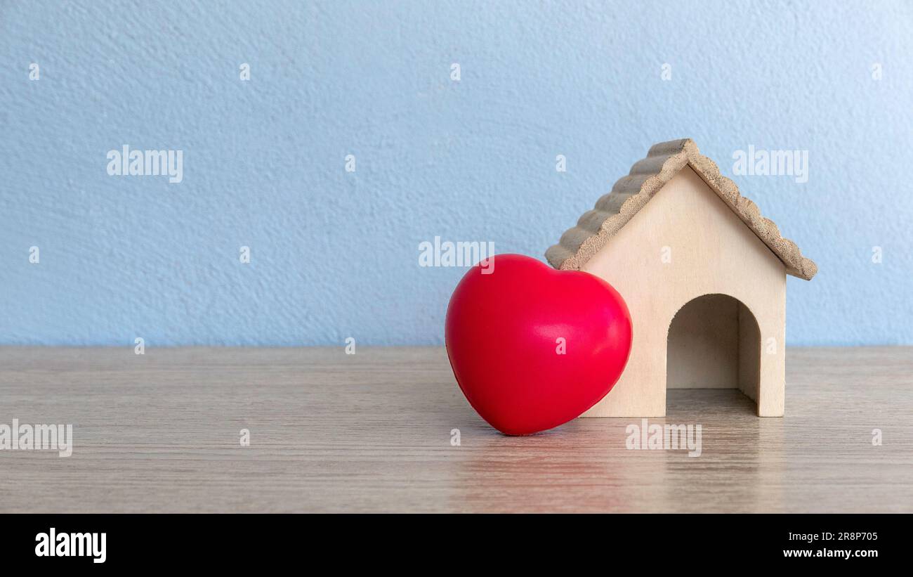 A house model and red heart love on table with copy space. Stock Photo