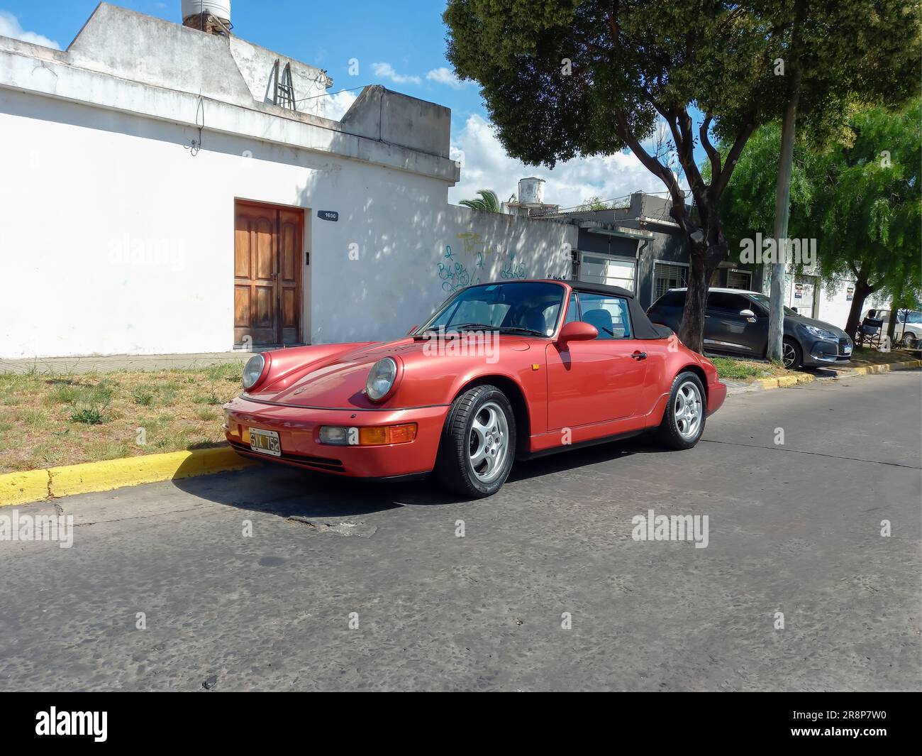 Old red sport 1990s Porsche 911 Carrera 2 Type 964 cabriolet turbo look speedster in the street. CADEAA 2023 Classic car show. Sunny day Stock Photo