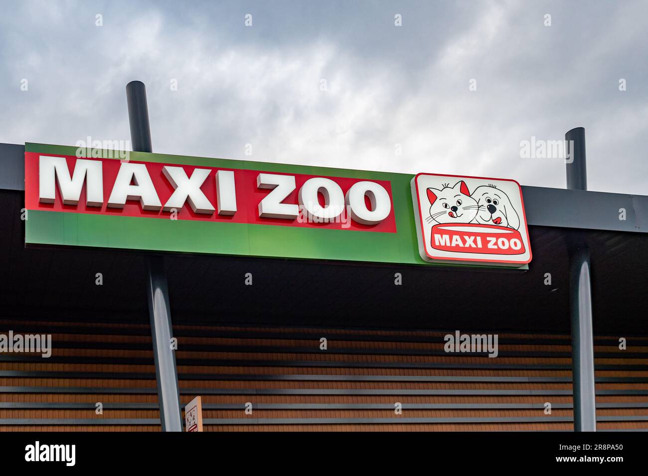 Closeup of a brightly-colored sign with the words 'Maxi Zoo' on the front of a store Stock Photo
