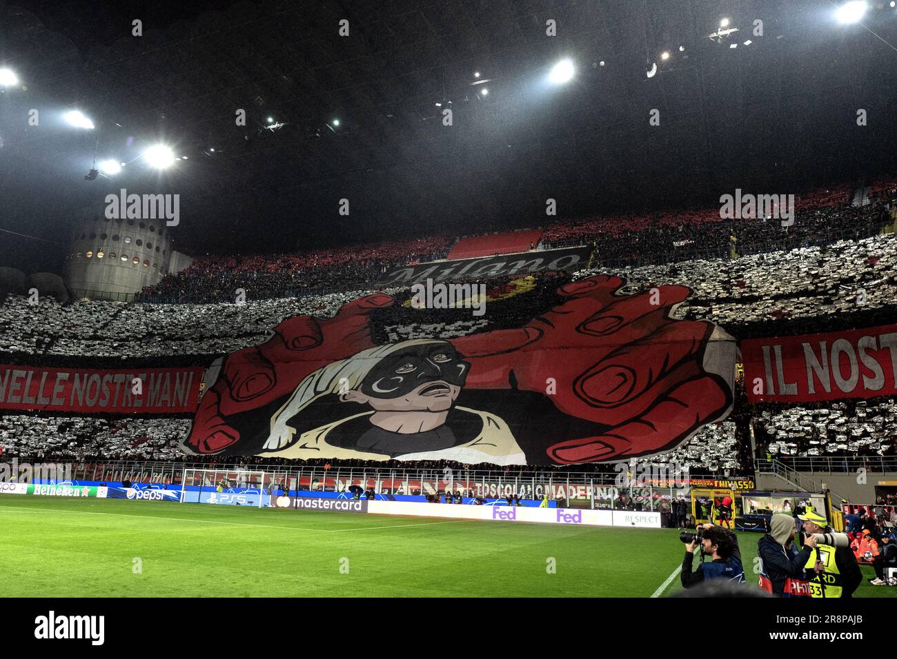 AC Milan football's fans coreography representing the devil (symbol of AC Milan) catchngi the Pulcinella puppet (symbol of Naples) Stock Photo
