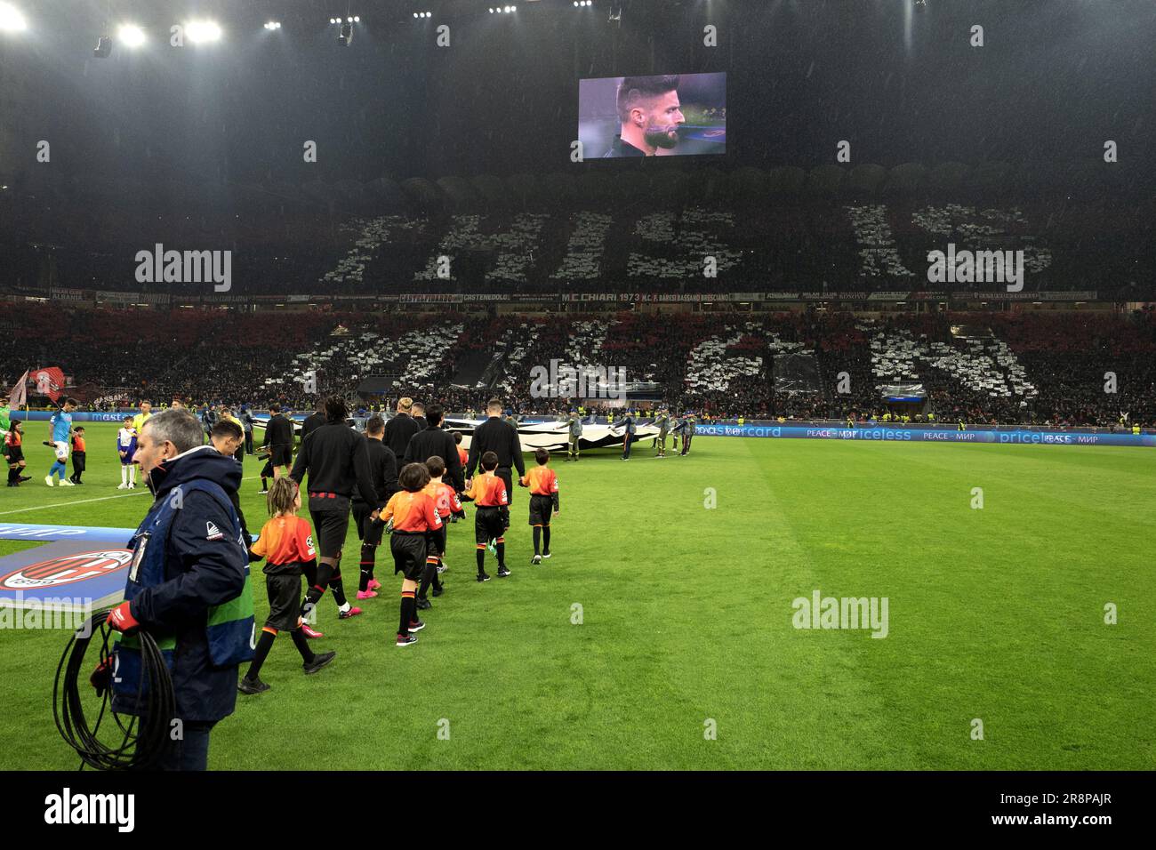 Football players enter the San Siro's stadium pitch, during the UEFA Champions League match AC Milan vs Napoli Stock Photo