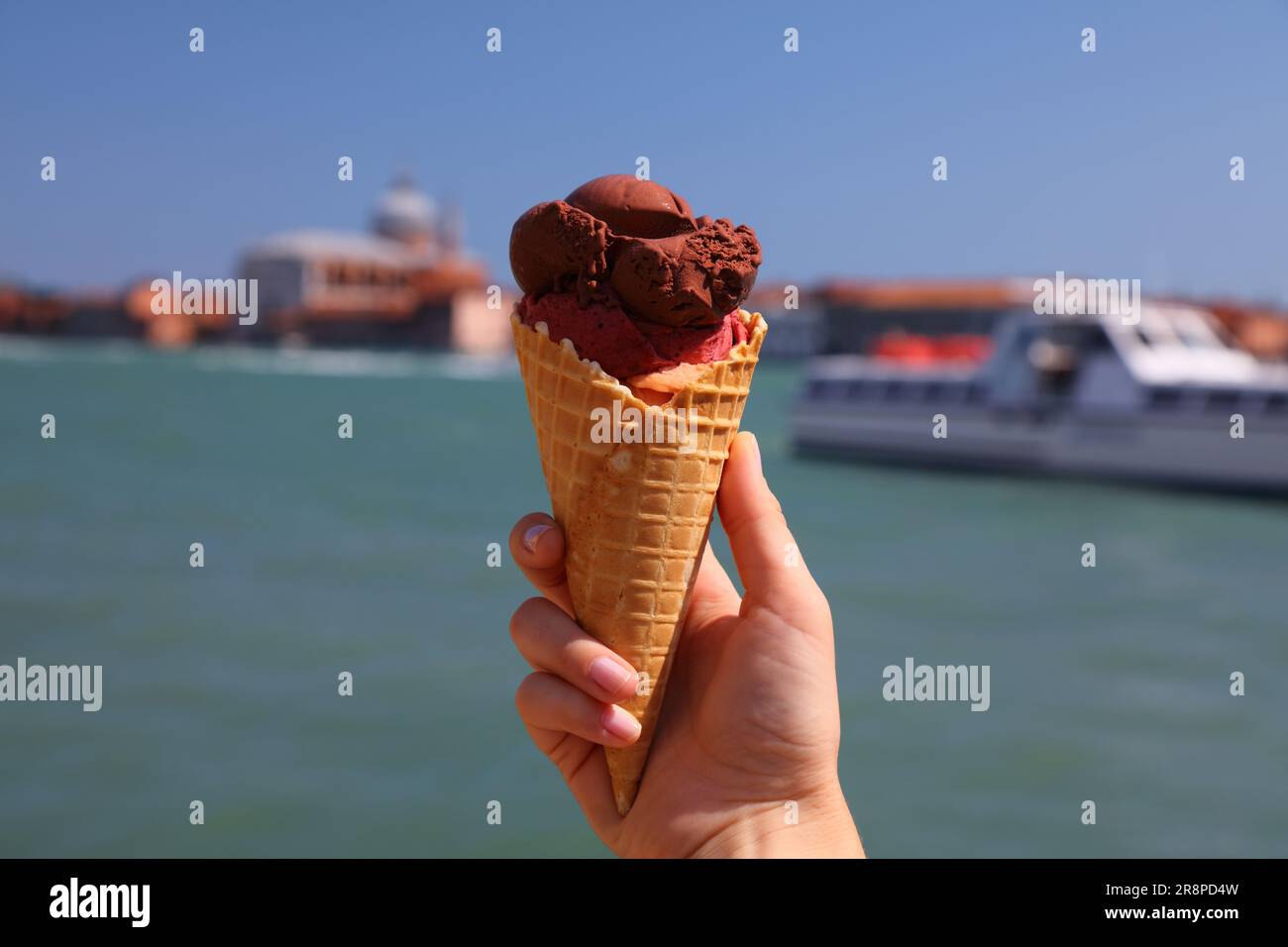 Ice cream in Venice, Italy. Hand holding Italian gelato ice cream in
