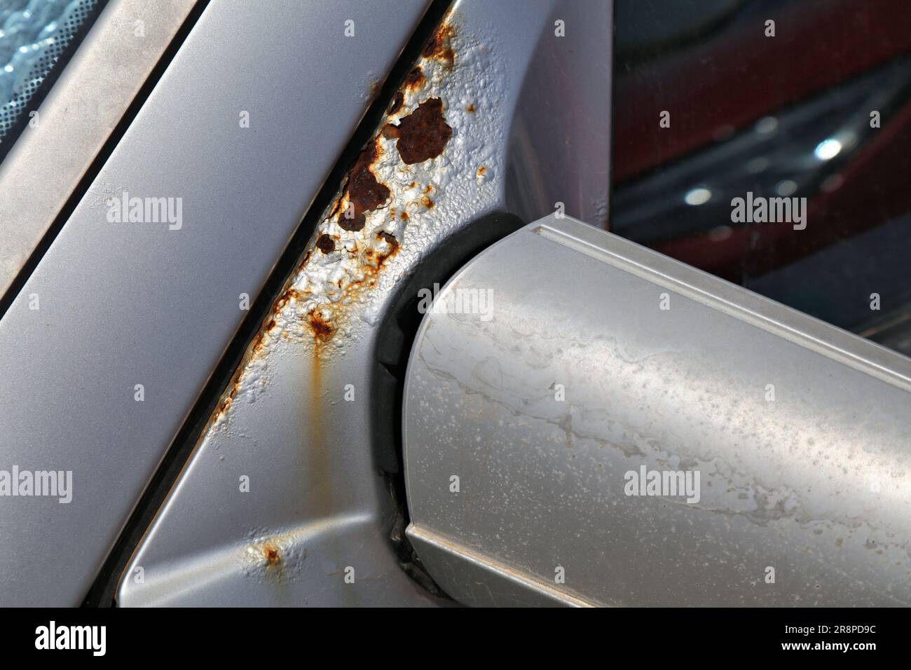 Rusty car door next to driver's mirror. Weather corrosion damage in vehicle Stock Photo Alamy