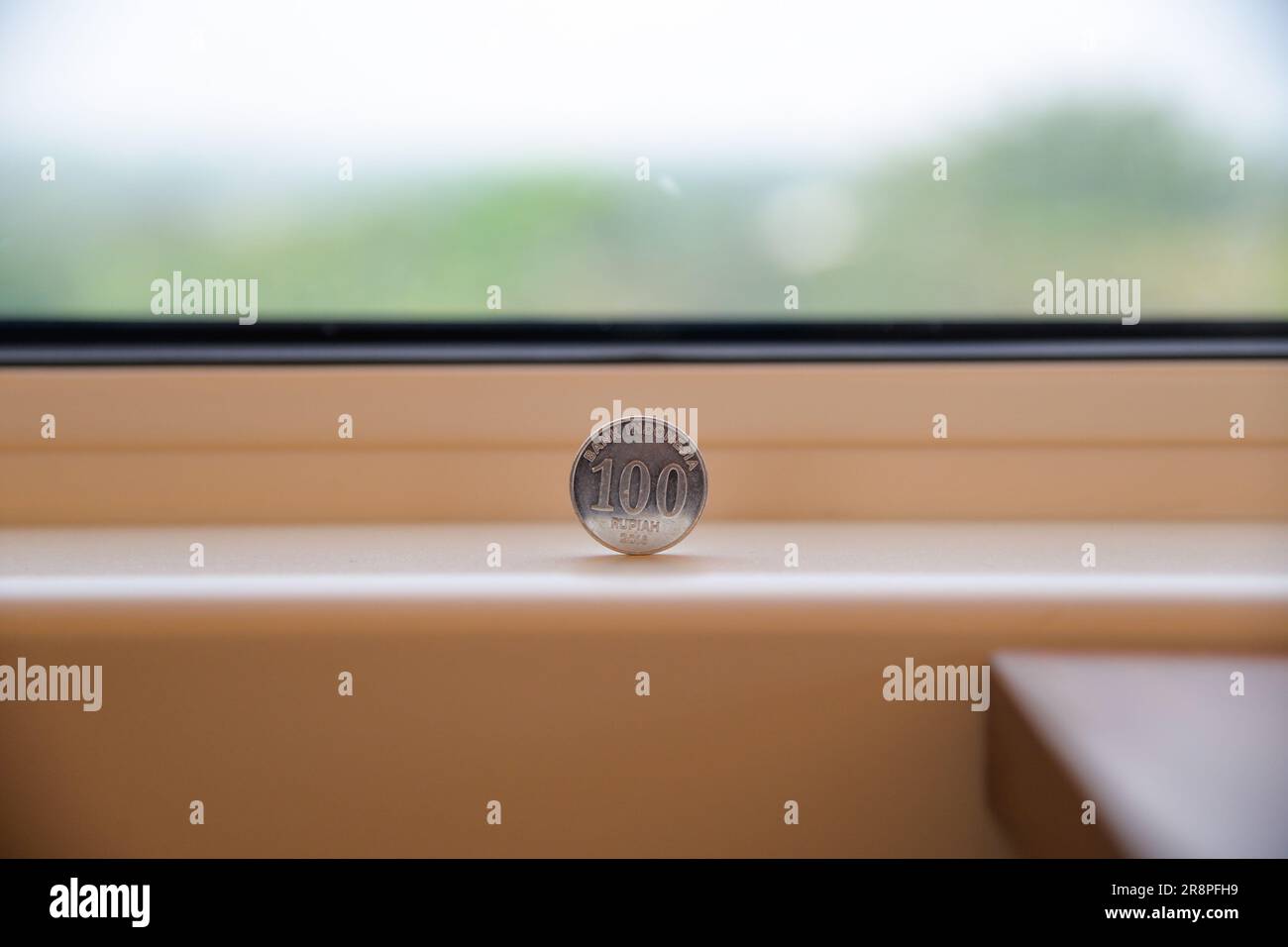 Jakarta. 22nd June, 2023. An Indonesian coin stands firmly on the  windowsill of a comprehensive inspection train during the joint  commissioning and testing phase for the Jakarta-Bandung High-Speed Railway  in Indonesia, June