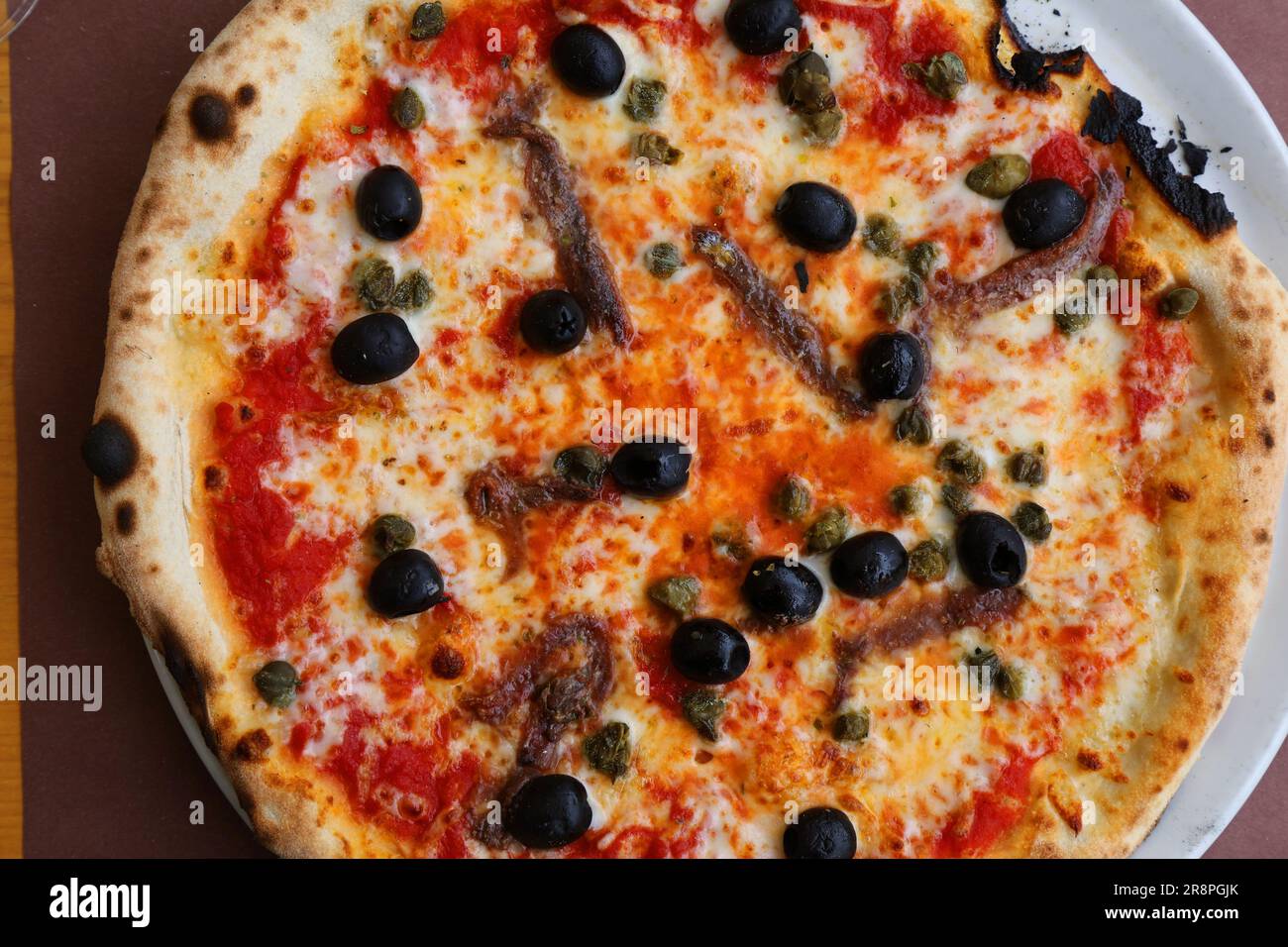 Italian pizza freshly served in a restaurant in Friuli Venezia Giulia region in Italy. Pizza