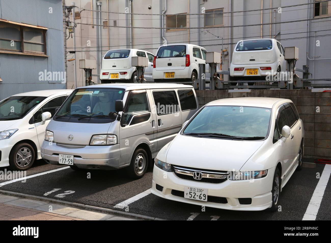 TOKYO, JAPAN - NOVEMBER 30, 2016: Nissan kei car, Honda and Suzuki cars parked in Tokyo, Japan. There are approximately 68.9 million cars registered i Stock Photo