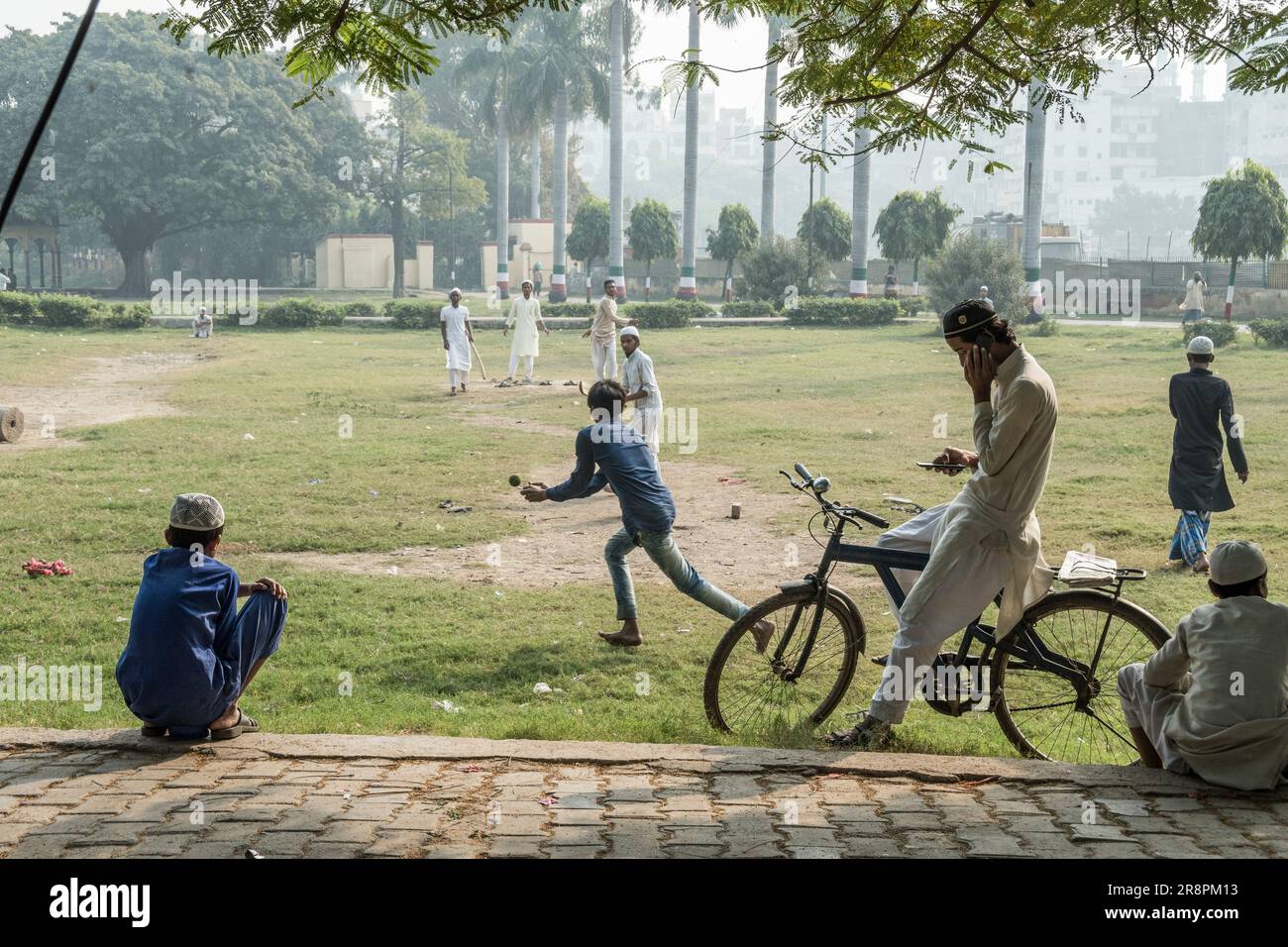 Boys play and watch cricket in Beniya Park, Varanasi, India Stock Photo
