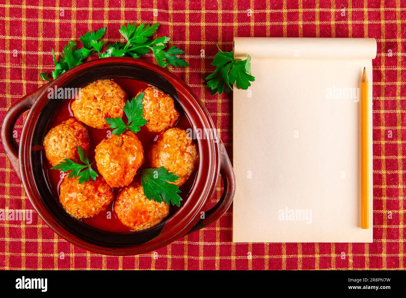 Blank recipebook and kottbullar meatballs in red sauce Stock Photo