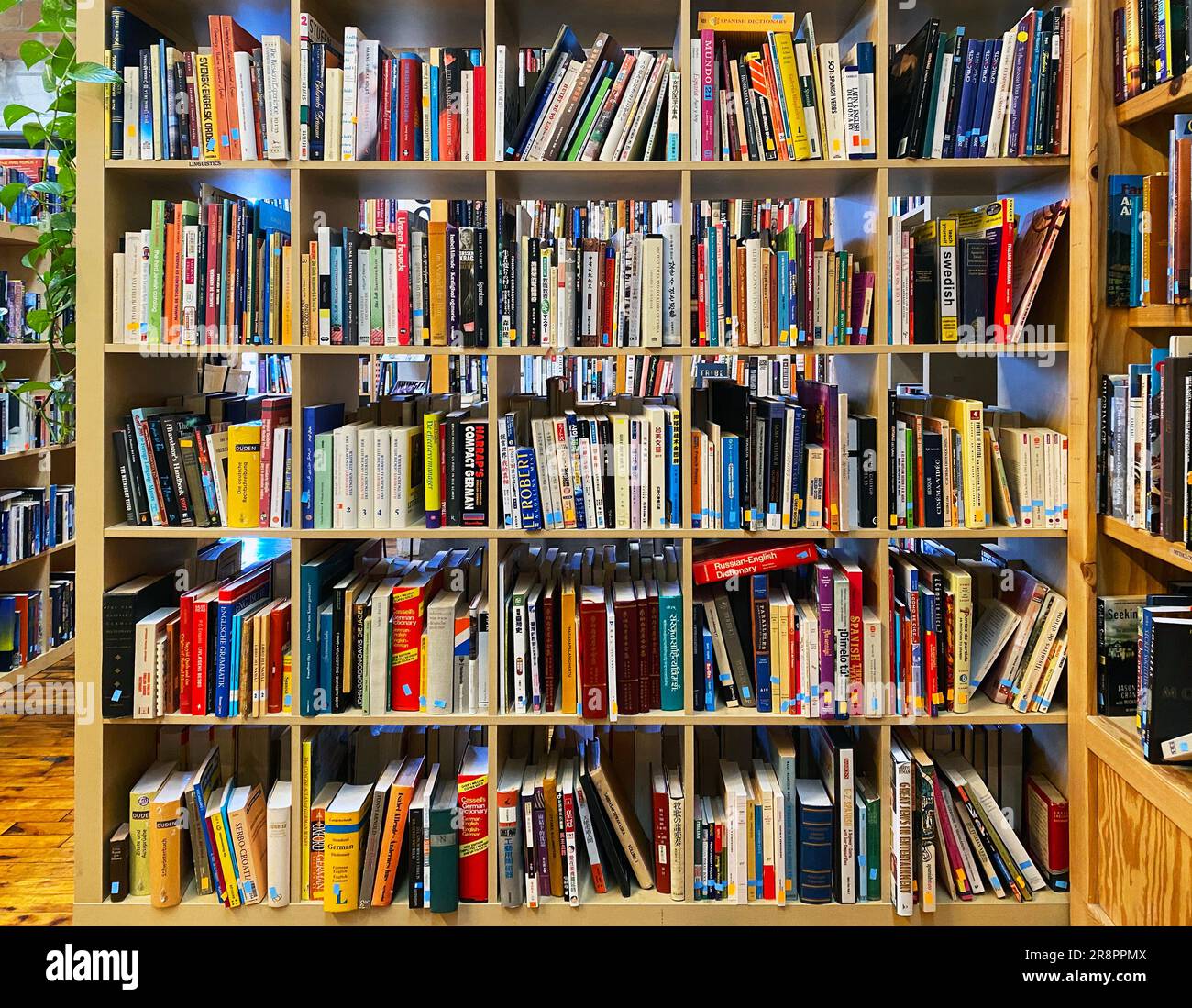 A bookshelf overflowing with books Stock Photo