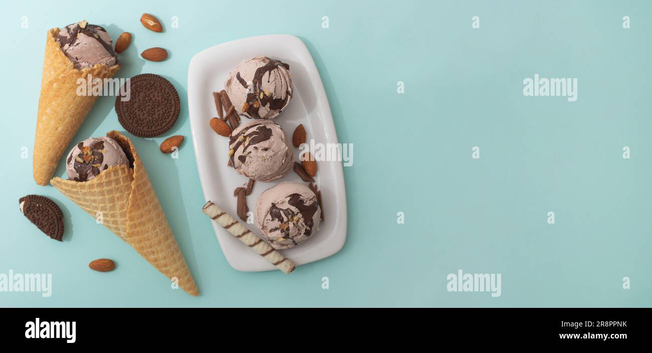 Chocolate ice cream in a waffle cone and on a white plate, decorated ...