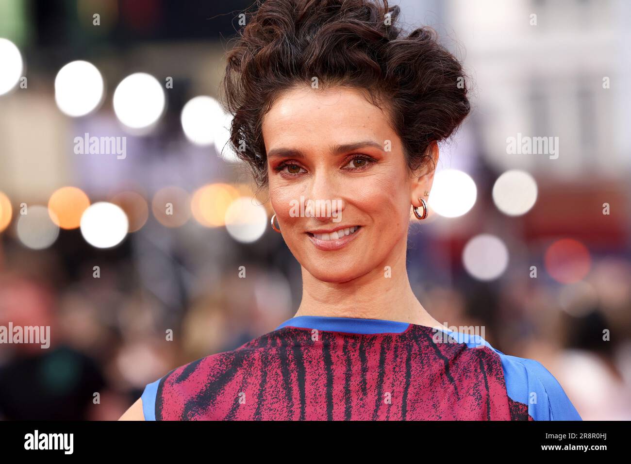 Indira Varma poses for photographers upon arrival at the premiere of