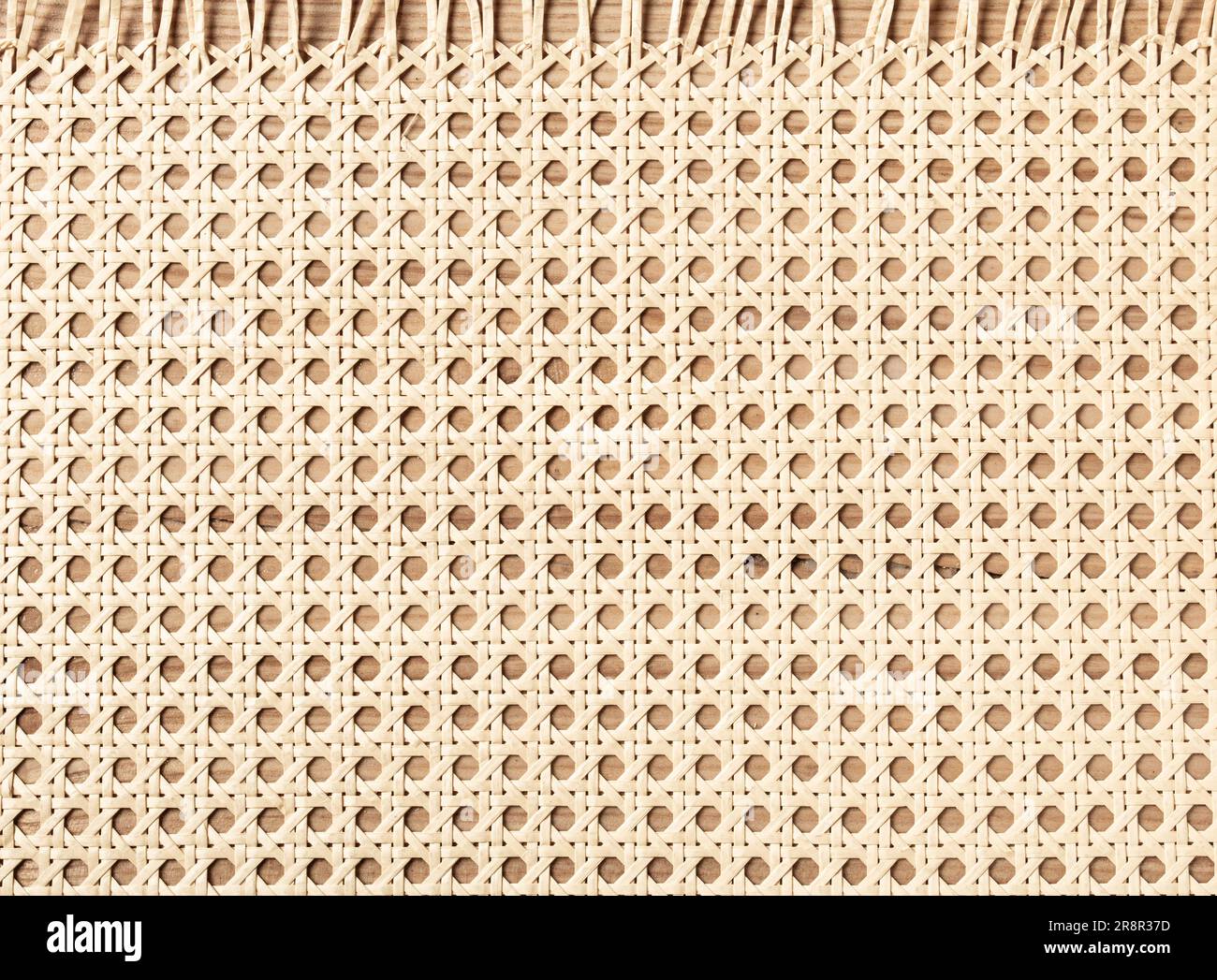 Embossed background of large-weave rattan stems. Stock Photo