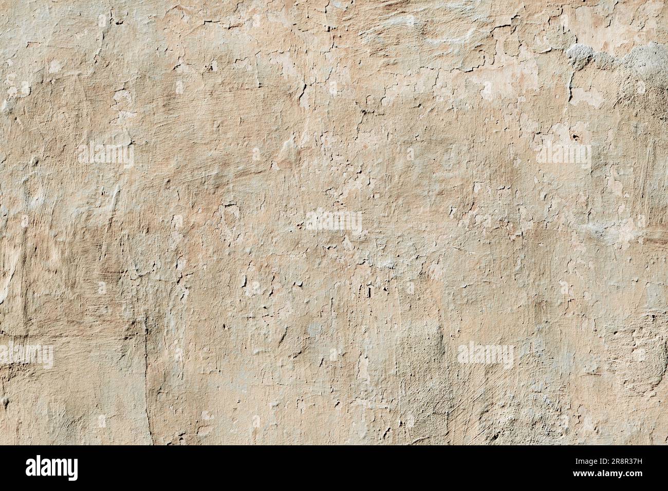 old wall covered with abstract cracked plaster. Stock Photo
