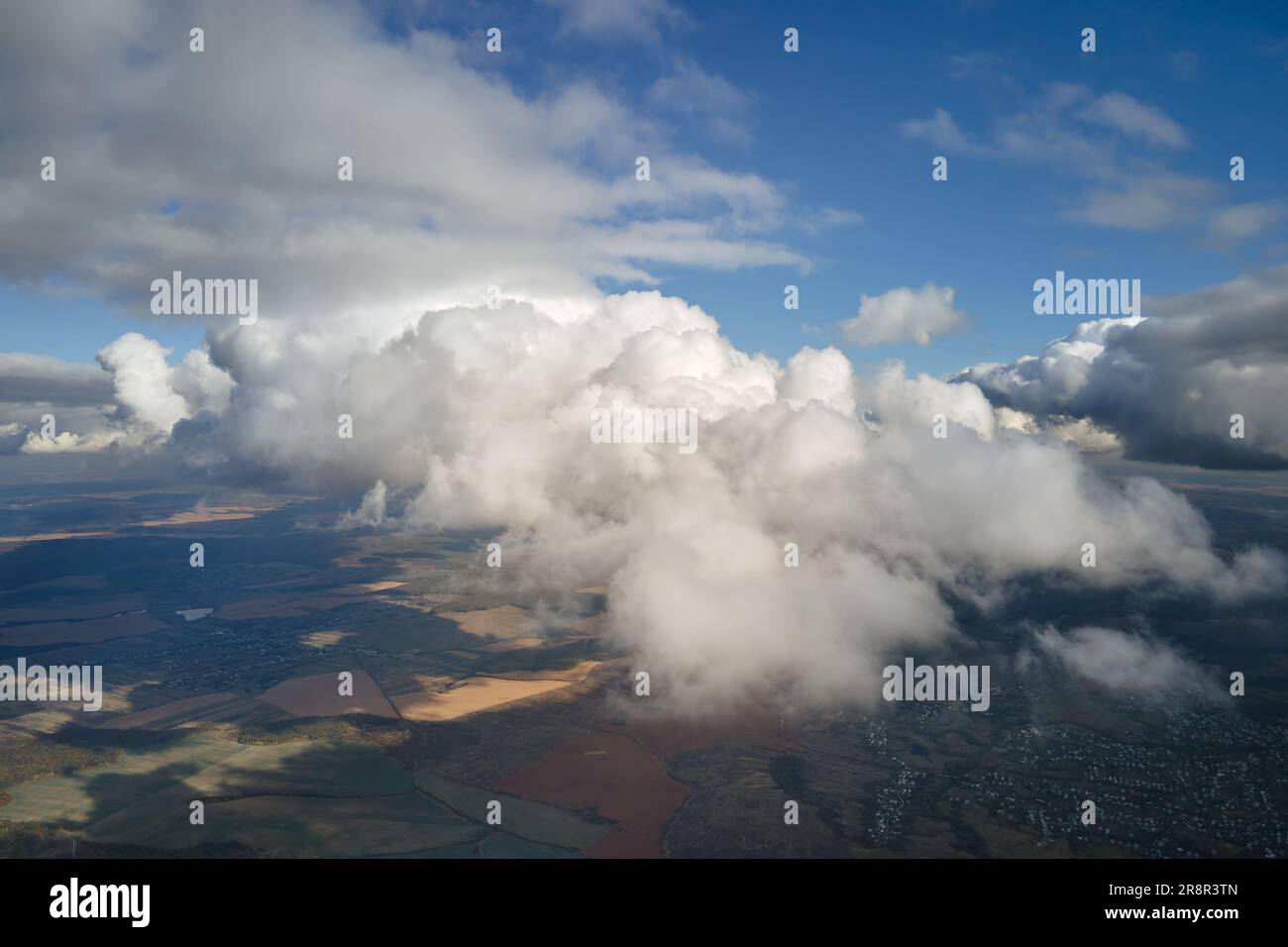 Aerial view at high altitude of earth covered with puffy cumulus clouds ...