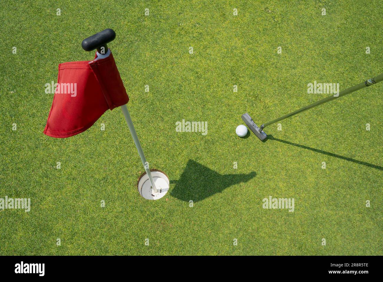 A putter golf club used for putting a golf ball into a hole, marked by