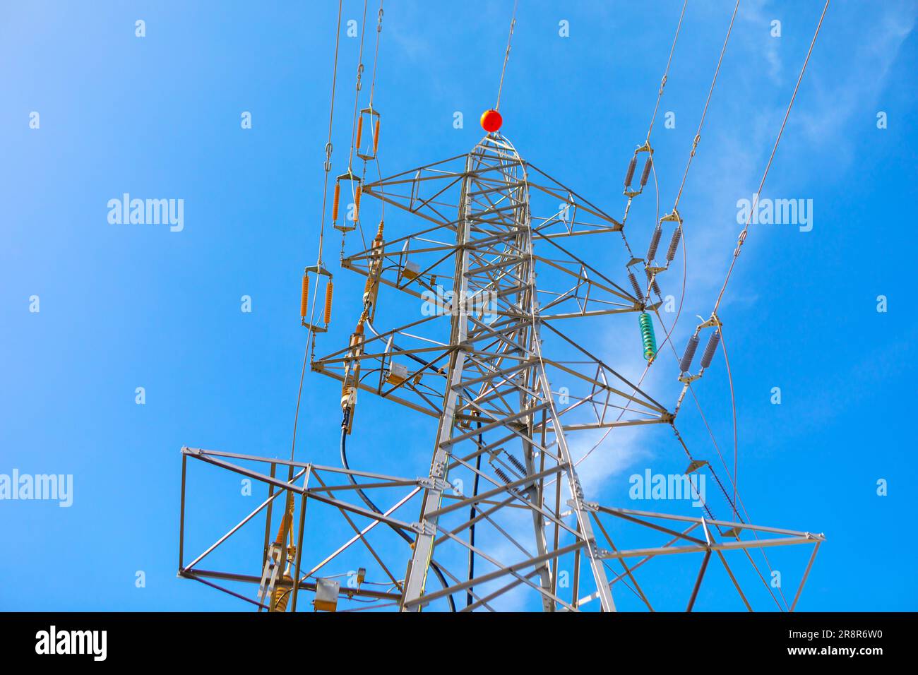 High voltage power line against blue sky background. Energy and ...