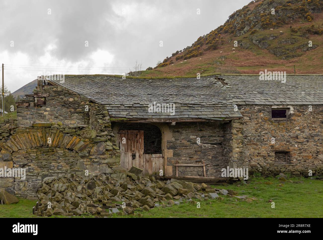Broken down old farm building with collapsed roof Stock Photo