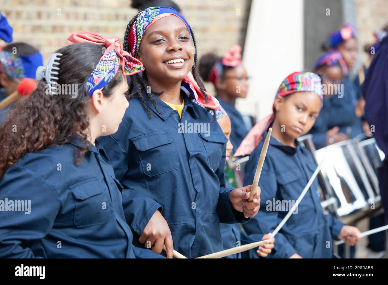 London, UK. 22nd June, 2023. children from the Kinetika Bloco band play steel pans and brass instruments in front of the war memorial in Windrush Square, Brixton. This was part of events to commemorate the 75th anniversary of the arrival of the Empire Windrush at Tilbury docks. Credit: Anna Watson/Alamy Live News Stock Photo