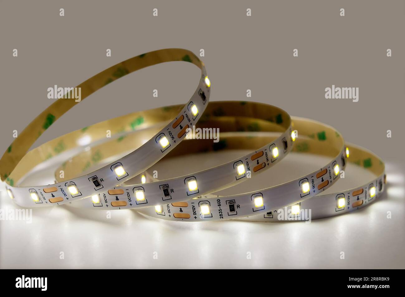 LED tape glowing white and rolled up in rings. Suitable for decorative