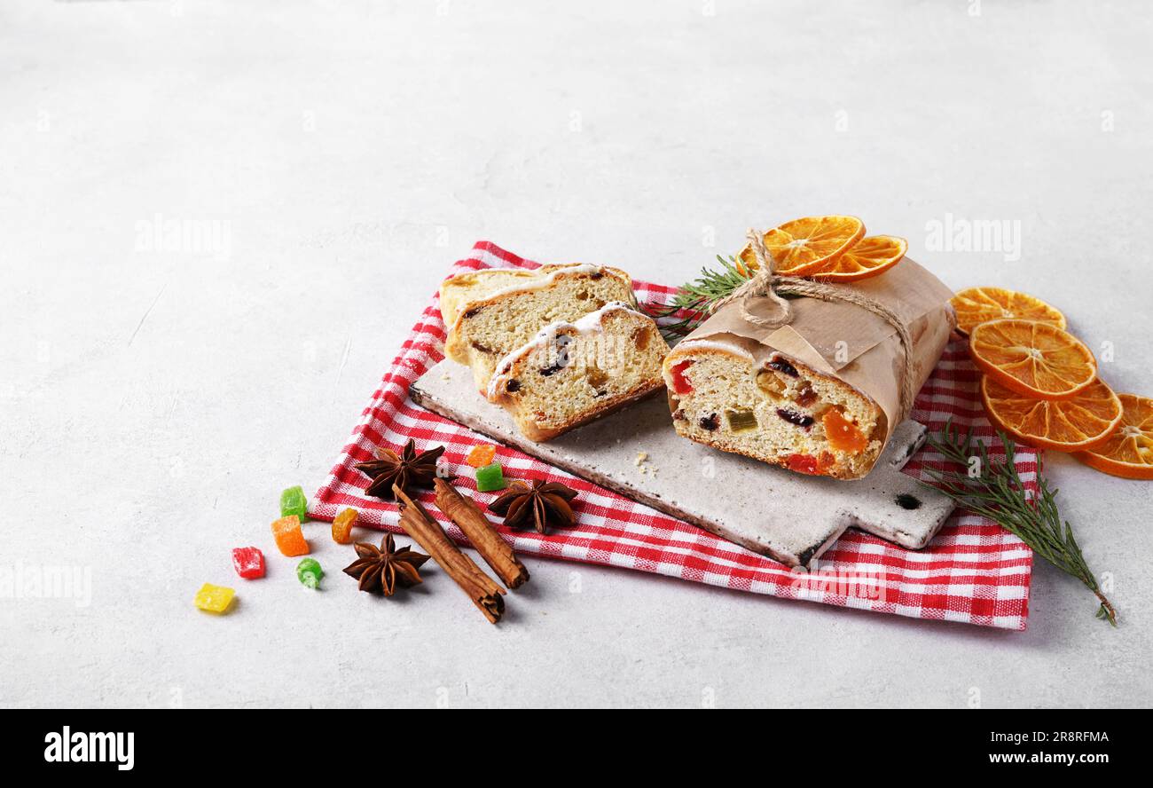 Christmas Stollen, sliced on red napkin with spices and decor. Homemade ...