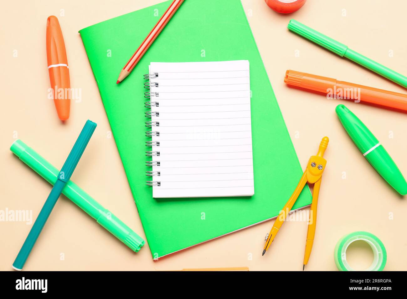 Notebooks with different stationery on pale orange background Stock Photo