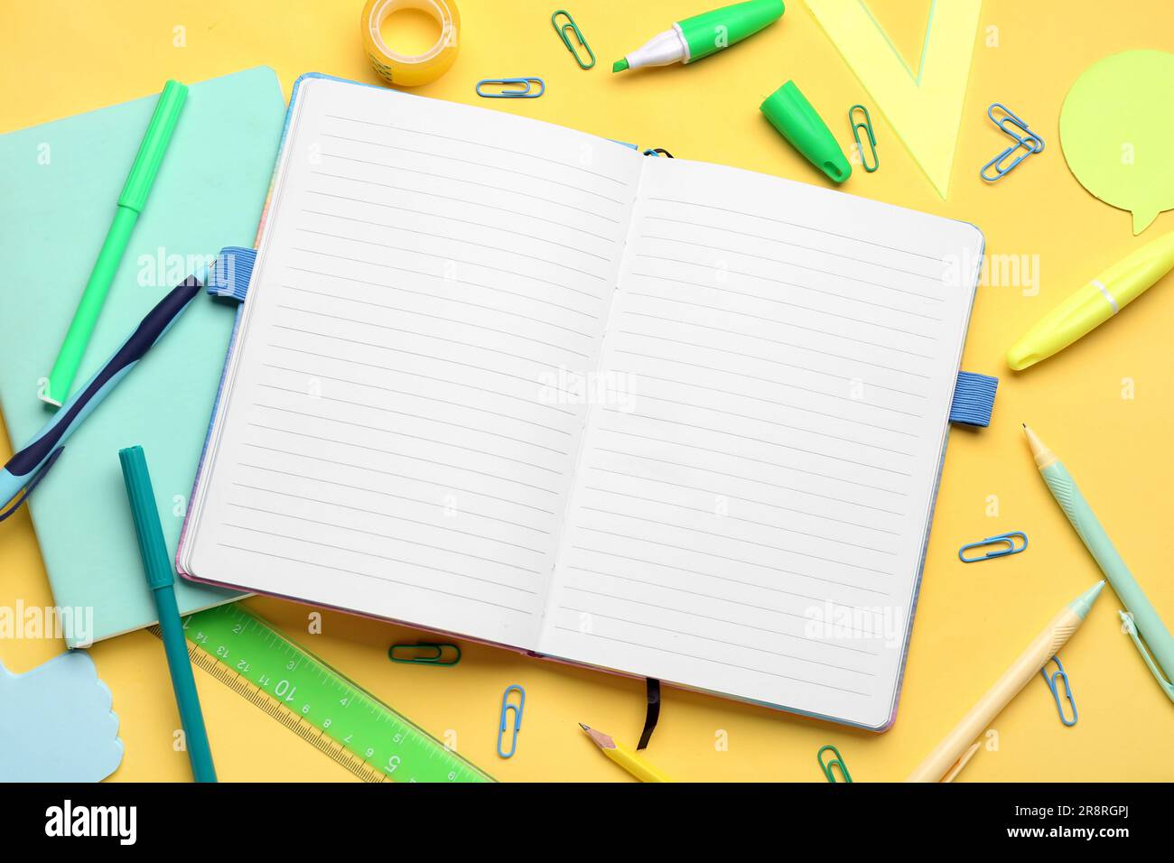 Notebooks with different stationery on pale orange background Stock Photo