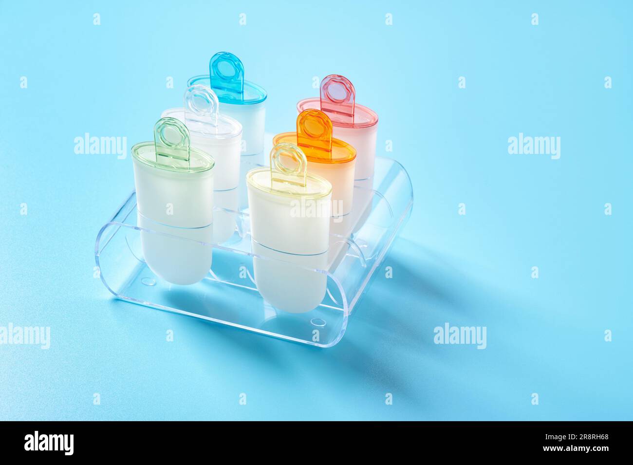 Plastic ice cream lolly form molds stand on plexiglas stand Stock Photo