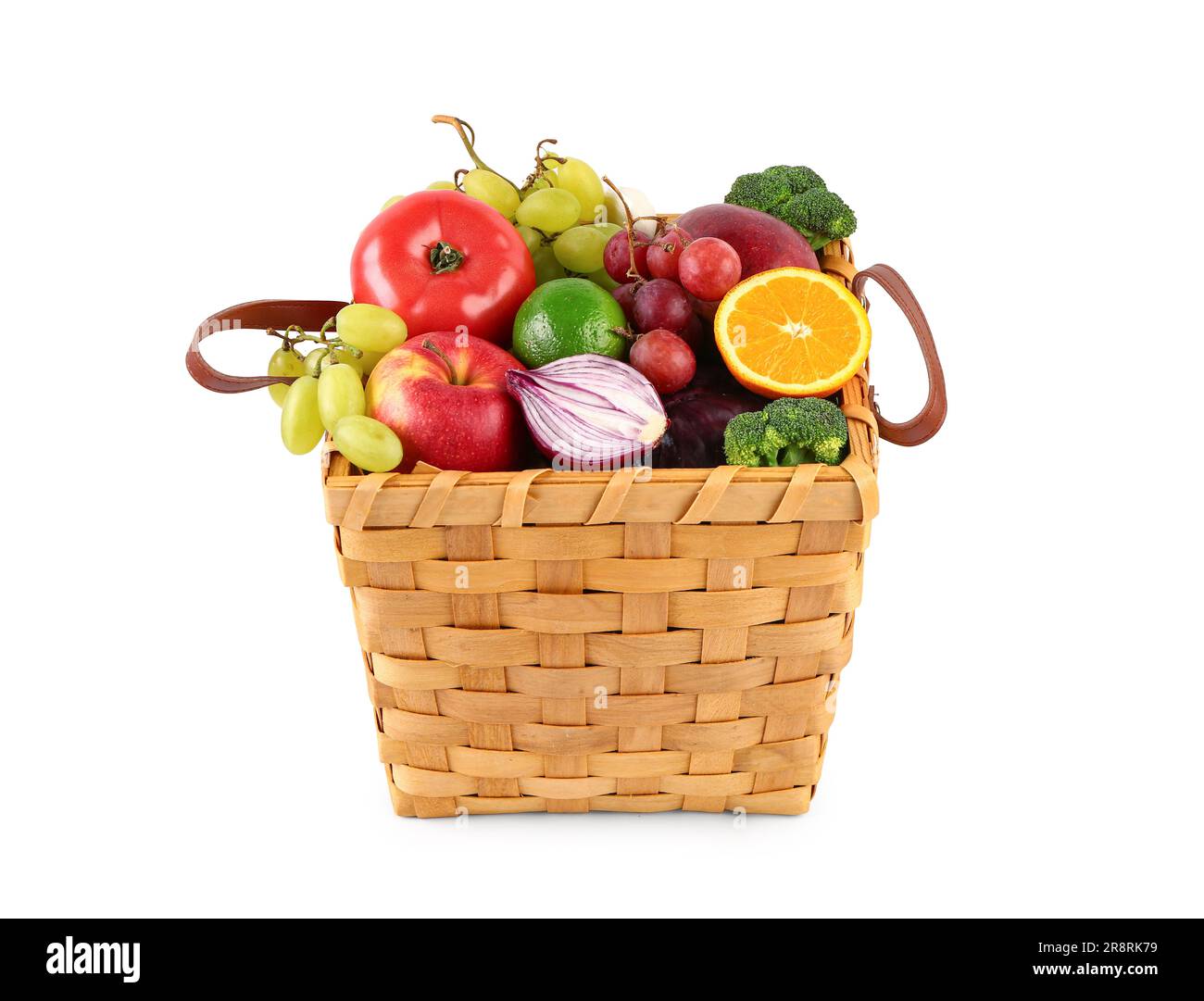 Wicker basket with different fresh fruits and vegetables on white ...