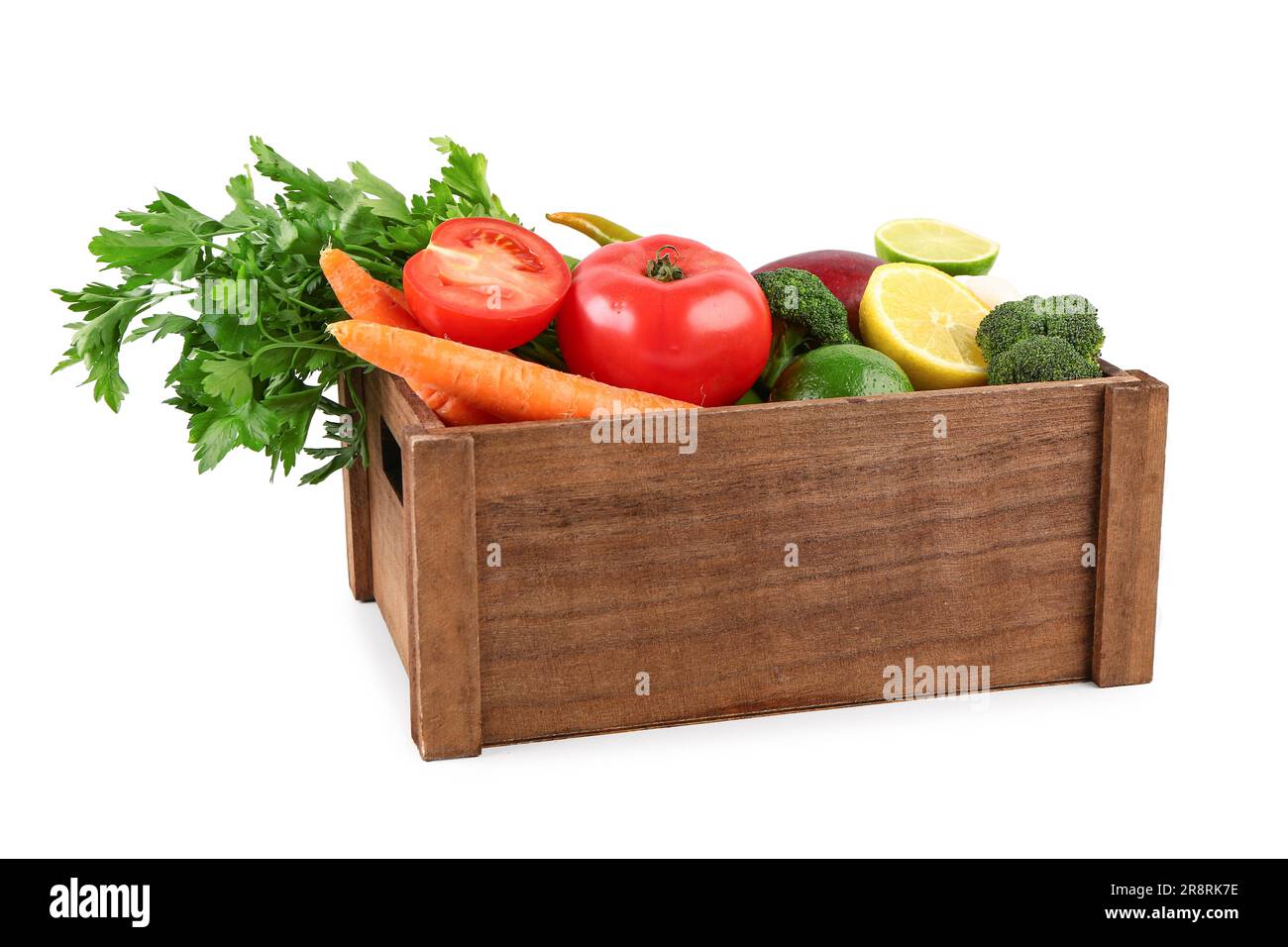 Wooden box with different fresh fruits and vegetables on white ...