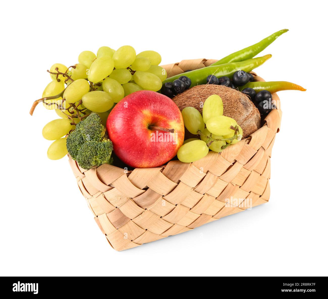 Wicker basket with different fresh fruits and vegetables on white ...