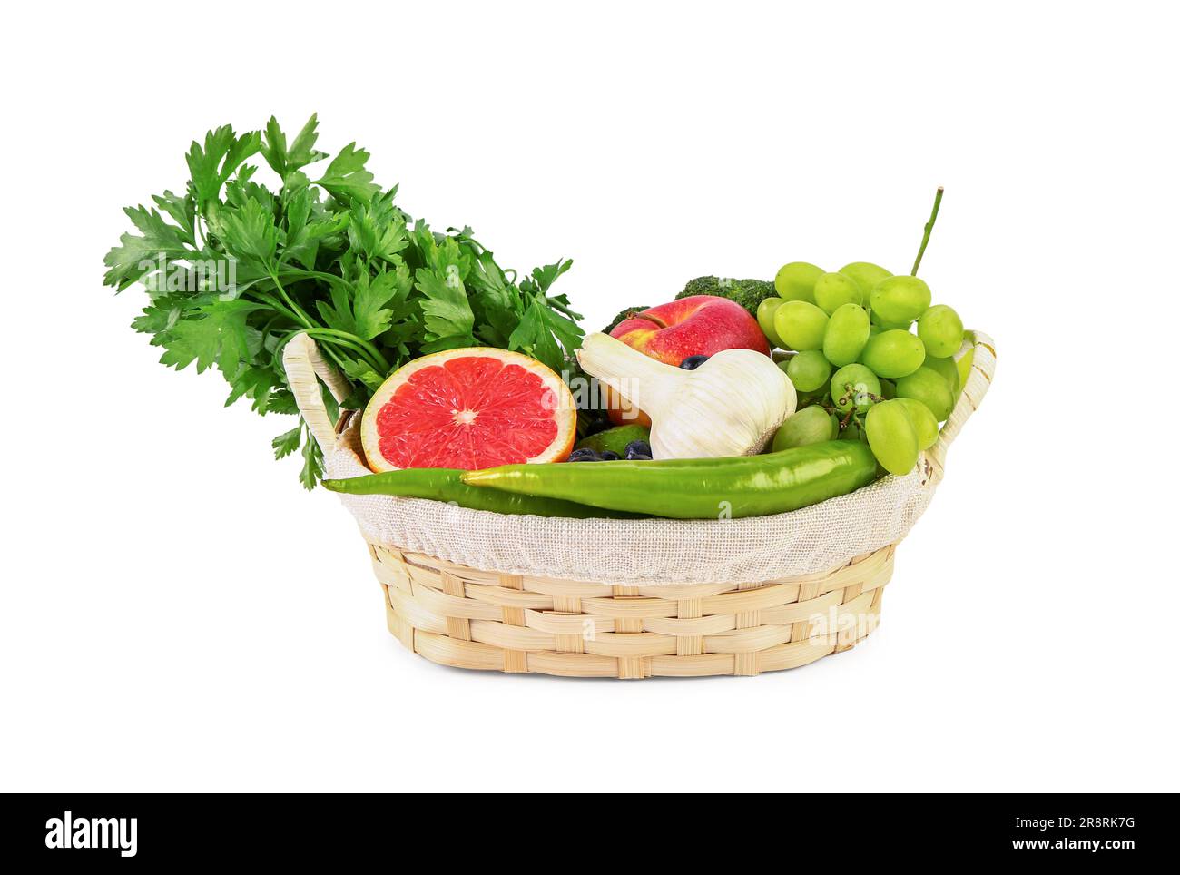 Wicker basket with different fresh fruits and vegetables on white ...