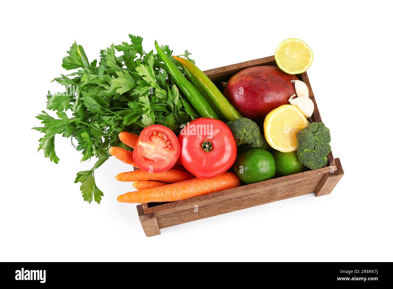 Wooden box with different fresh fruits and vegetables on white ...