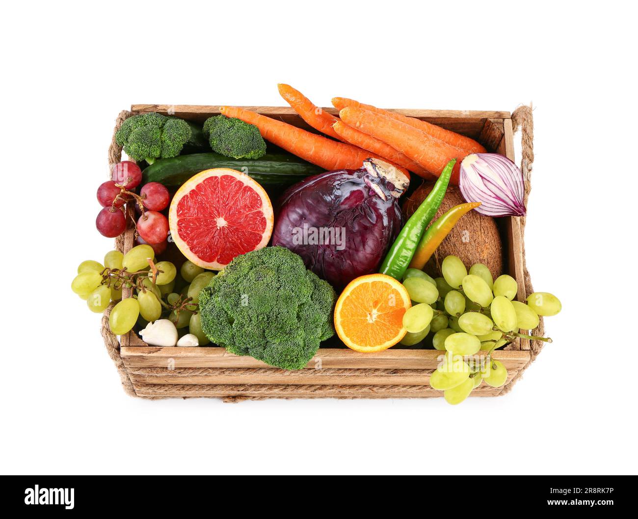 Wooden box with different fresh fruits and vegetables on white ...