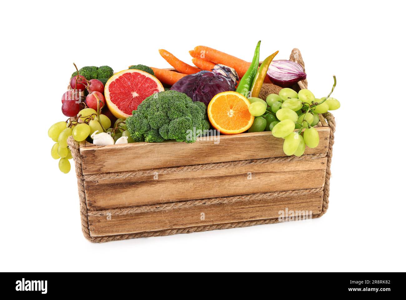 Wooden box with different fresh fruits and vegetables on white ...