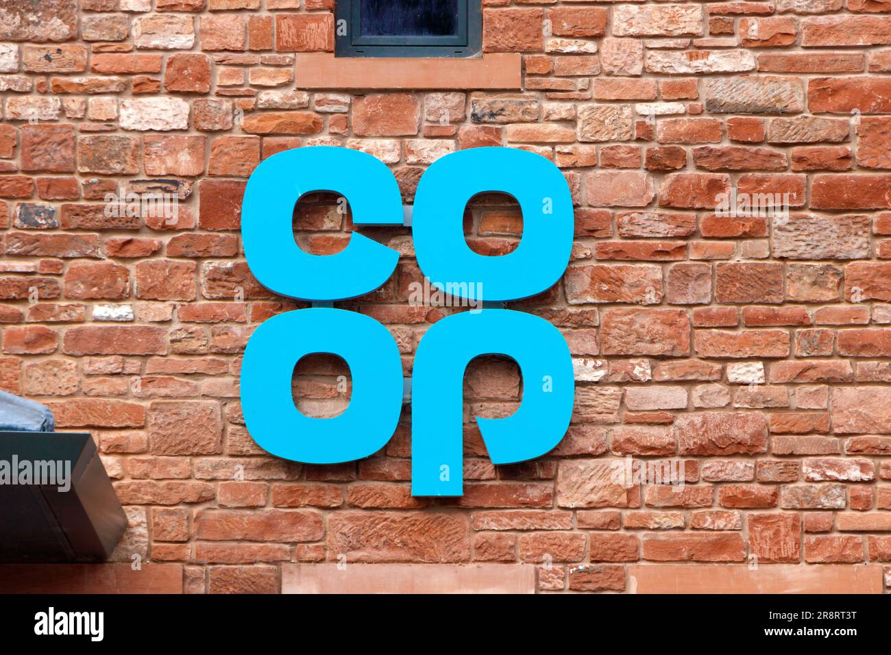 blue co op supermarket sign logotype on sandstone wall in appleby June 2023 cumbria. Stock Photo