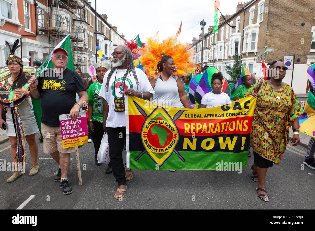 London, UK. 23rd June, 2023. A procession through Brixton, along Railton Road to Windrush Square, marked the 75th anniversary of the Empire Windrush docking at Tilbury. One of the banners carried called for reparations. Credit: Anna Watson/Alamy Live News Stock Photo