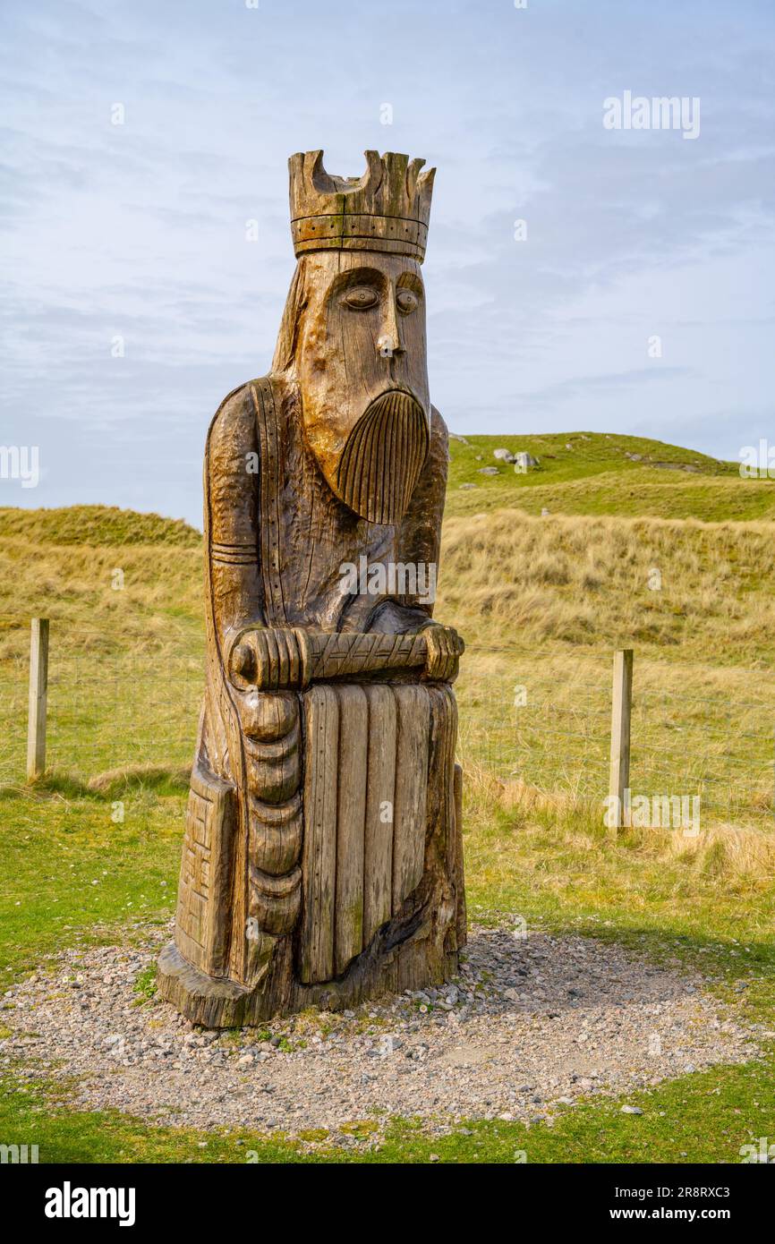 Wooden carving of one of the Lewis chessmen on the beach at Uig. Stock Photo