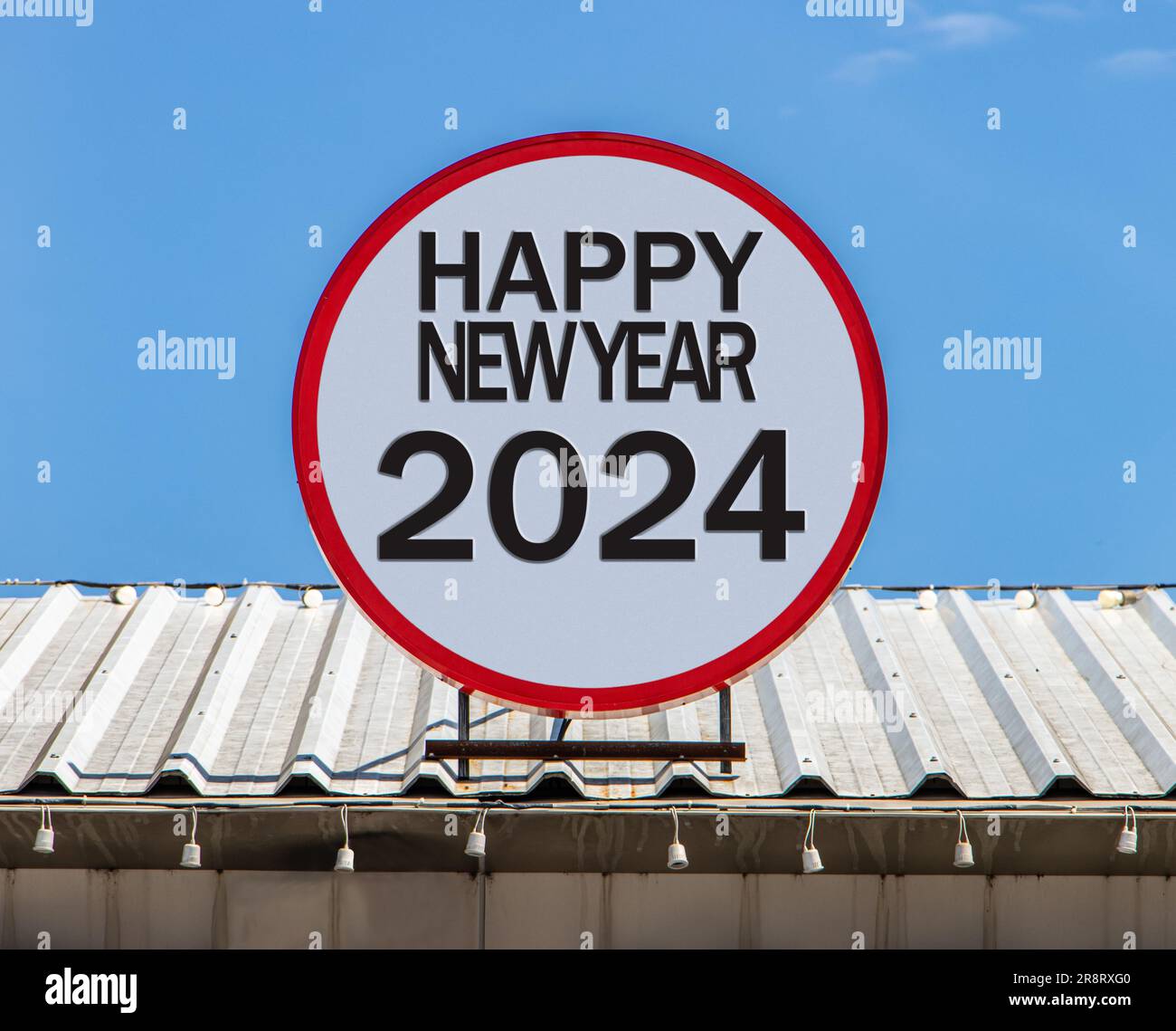 A Circle billboard with text Happy New Year 2024, is installed on a roof. Greeting for New Year. Stock Photo
