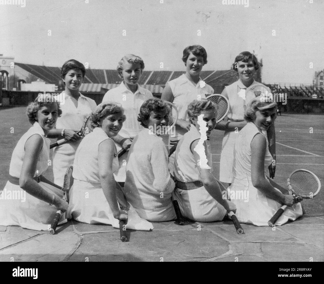 Tennis Hopefuls -- Members of the National Junior Wightman Cup squad pose for team picture at West Side Tennis Club here yesterday. Left to right (front) are Marry Ann Eilenberger of San Diego, Calif.; Darlene Hard of Montebello, Calif.; Mary Slaughter of Charlottesville, Va.; Suzanne Her of Miami beach, Fla.; Karol Fageros of Coral Gables, Fla.; (rear) Susan Bralower of White Plains, N.Y.; Jean Laird of Modesto, Calif.; Pat Stewart of Indianapolis, Ind., and Bonnie Mackay of Dayton, Ohio. August 31, 1953. (Photo by AP Wirephoto). Stock Photo