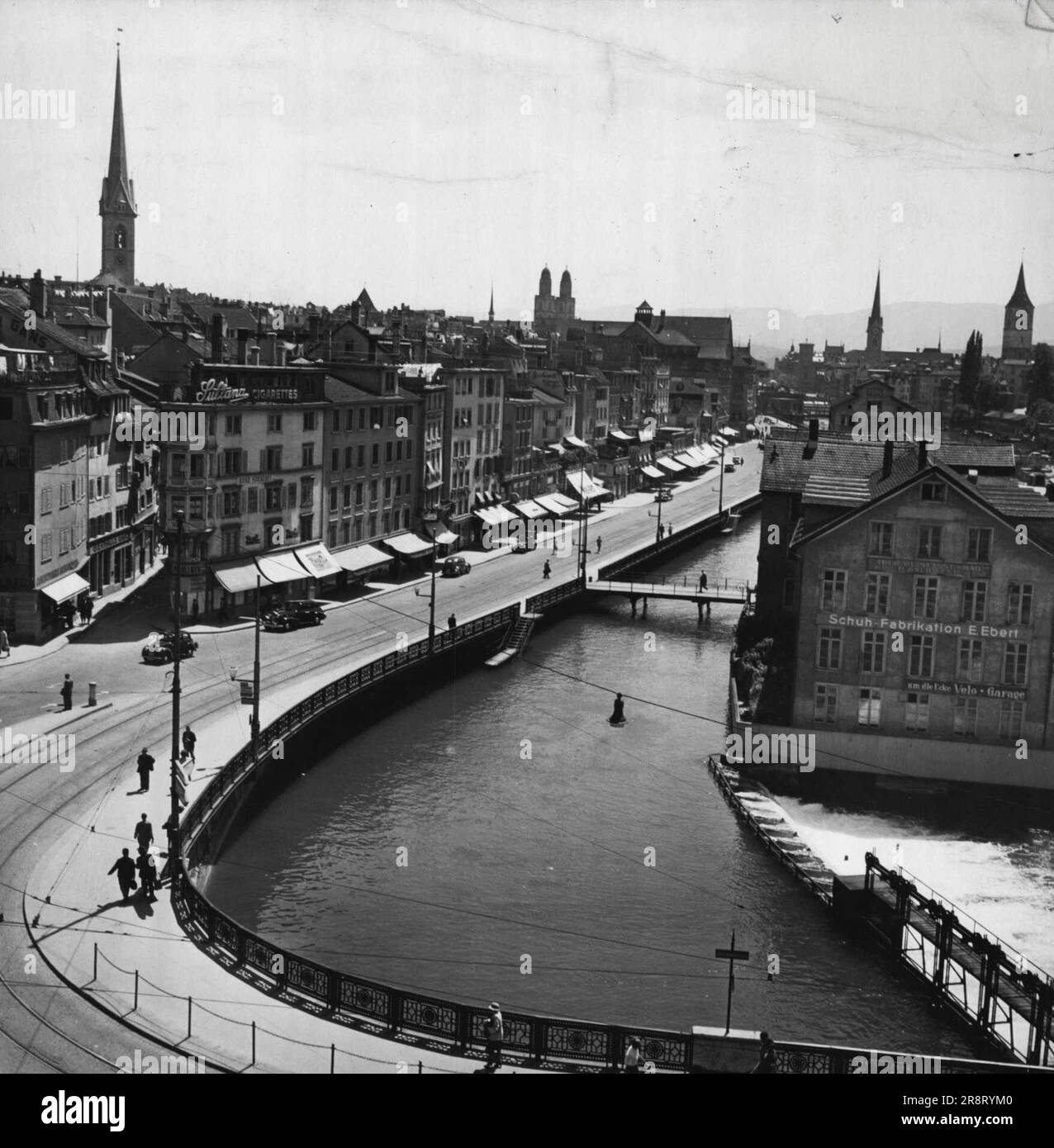 Zurich, principal city of Switzerland. General view showing the River Limmat. On the left the Limmatquai; in the distance the twin-steepled Grossmunster Cathedral. August 16, 1953. (Photo by Camera Press). Stock Photo