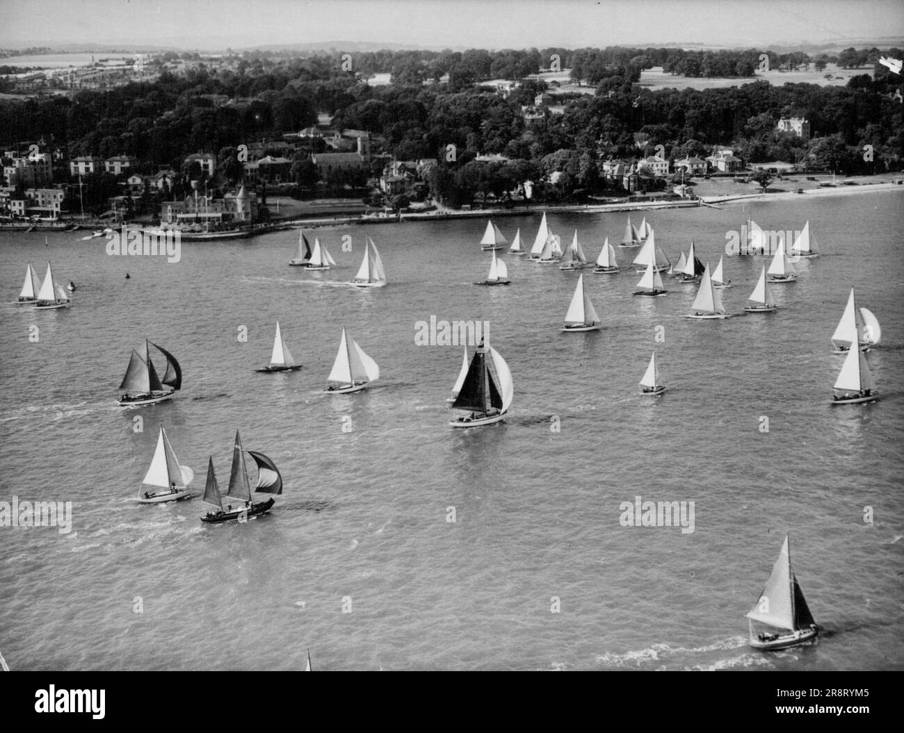 Spinnakers Filled A Stiff Following, Breeze fills the spinnaker sails of some of the 103 craft of the 5 to 25 ton Yachts as they scud along before the wind off cores, isle of Wight, July 9. They were taking part in the race Round the Island Organised by the isle of night Sailing Club. July 26, 1949. (Photo by Associated Press Aerial) Stock Photo