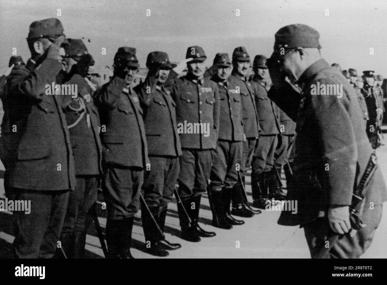 War Minister Tojo Inspects -- War Minister, right exchanging greetings with General Juzo Nisho, supreme commander of the Japanese forces in China, at Nanking. War Fields in China.... It was announced War Minister General fronts, after inspection tour. December 23, 1940. (Photo by The Domei News Photos Service). Stock Photo