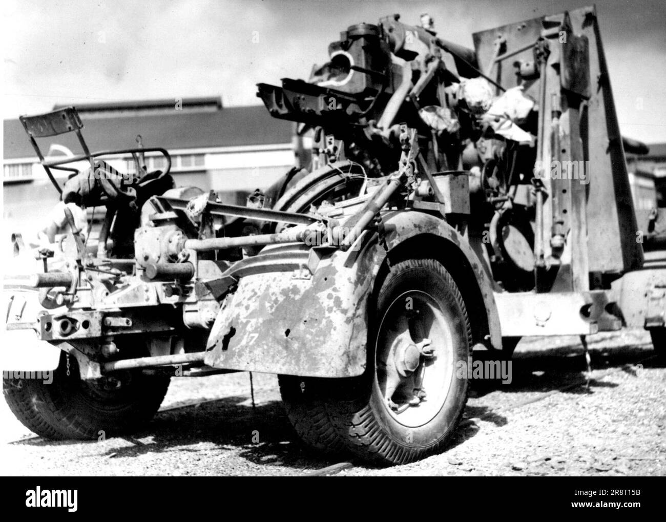 Bullet holes punched in its mudguard, this German 88 mm gun now sits forlornly in an Australian street after rolling triumphantly down the Western Desert to El Alamein where it was captured by men of the Ninth Division. March 8, 1943. Stock Photo