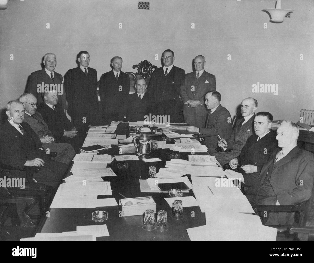 Change Conference Delegates at the Australian Stock Exchanges conference, which will continue until the end of the week. L. To R., stnading: Messrs. A. C. L. Lamb, Perth; R. A. Chandler, Hobart; F. E. Tilley, Sydney; A. D. Young, Adelaide; D. M. Corrie, Brisbane. Seated: Messrs. A. Hamilton, New Zealand; H. Maxwell, Sydney; H. R. Osborne, Sydney; R. A. Rowe, Melbourne (chairman); G. D. Brown (Secretary); H. C. Collingwood, Melbourne; L. H. Laidlaw, Adelaide; and W. C. Burrows, Hobart. August 18, 1947. Stock Photo